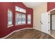 Bedroom with red wall, wood floors, three windows allowing ample natural light at 25871 E 5Th Pl, Aurora, CO 80018