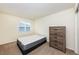 Neutral bedroom featuring a window with blinds, a dresser and space for relaxing at 25871 E 5Th Pl, Aurora, CO 80018