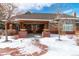 Front view of community clubhouse with stone accents and snowy walkway at 25871 E 5Th Pl, Aurora, CO 80018