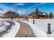 View of community clubhouse with a walkway in the winter at 25871 E 5Th Pl, Aurora, CO 80018