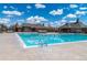 Inviting community pool with clear blue water surrounded by lounge chairs and well-maintained grounds for relaxation and enjoyment at 25871 E 5Th Pl, Aurora, CO 80018