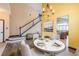 Well decorated dining area featuring high ceilings, a modern chandelier, and stairs to the 2nd story at 25871 E 5Th Pl, Aurora, CO 80018