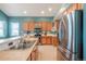 Well-lit kitchen with stainless steel appliances and breakfast bar at 25871 E 5Th Pl, Aurora, CO 80018