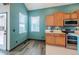 This kitchen features stainless steel appliances, wood cabinets, an eat-in area, and views to the outside at 25871 E 5Th Pl, Aurora, CO 80018