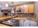 Close-up of the basement kitchenette featuring a beer dispensing system and sleek wood countertops at 25871 E 5Th Pl, Aurora, CO 80018