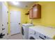 Spacious laundry room includes a washer, dryer, storage cabinets and counter at 25871 E 5Th Pl, Aurora, CO 80018