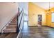 Open-concept living room with hardwood floors, high ceilings, and a staircase to the upper level at 25871 E 5Th Pl, Aurora, CO 80018