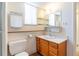Well-lit bathroom with updated vanity, toilet, and open shelving for convenient storage at 2700 S Holly St # 115, Denver, CO 80222