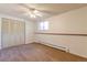 Bright bedroom with a ceiling fan, closet and baseboard heat at 2700 S Holly St # 115, Denver, CO 80222