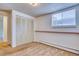 This bedroom features a closet, window, and neutral carpeting to create a warm, cozy space at 2700 S Holly St # 115, Denver, CO 80222