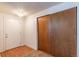 Bright entryway with wood laminate flooring, closet with sliding doors, and a white front door at 2700 S Holly St # 115, Denver, CO 80222