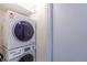 Convenient laundry area with stacked washer and dryer units for space-saving efficiency at 2700 S Holly St # 115, Denver, CO 80222