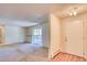 Spacious living room with neutral carpet and a sliding glass door leading to the outside at 2700 S Holly St # 115, Denver, CO 80222