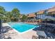 Outdoor pool surrounded by lounge chairs and tables near the community condos at 2700 S Holly St # 115, Denver, CO 80222