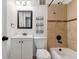 Well-lit bathroom with modern fixtures and a shower-tub combo at 5123 Milwaukee St, Denver, CO 80216