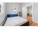 Bedroom with hardwood floors, neutral walls, and a comfortable bed under a window at 5123 Milwaukee St, Denver, CO 80216