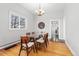 Well-lit dining room featuring hardwood floors, neutral walls, and view to Gathering room at 5123 Milwaukee St, Denver, CO 80216
