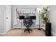 Dedicated home office area features a modern desk setup with multiple monitors and ample natural light at 5123 Milwaukee St, Denver, CO 80216