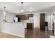Open concept kitchen with dark cabinets, stainless steel appliances, and hardwood floors at 5123 Milwaukee St, Denver, CO 80216