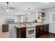 Open concept kitchen featuring granite countertops, stainless steel appliances, and open shelving at 5123 Milwaukee St, Denver, CO 80216
