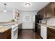 Well-lit kitchen featuring dark cabinets, granite countertops, and stainless steel appliances at 5123 Milwaukee St, Denver, CO 80216
