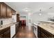 Kitchen with wood floors, granite countertops, dark wood cabinets, and stainless steel appliances at 5123 Milwaukee St, Denver, CO 80216