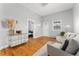 Open living space with hardwood floors, neutral walls, and access to the bedroom at 5123 Milwaukee St, Denver, CO 80216