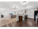 Open concept living room and kitchen featuring hardwood floors, carpet, and modern finishes at 5123 Milwaukee St, Denver, CO 80216