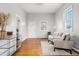 Bright living room with hardwood floors, neutral walls, and comfortable seating near a large window at 5123 Milwaukee St, Denver, CO 80216