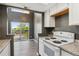 Bright kitchen with white appliances and a great view of the outside balcony at 19192 E Wyoming Pl # 206, Aurora, CO 80017