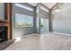Spacious living room featuring a brick fireplace and access to the deck at 19192 E Wyoming Pl # 206, Aurora, CO 80017