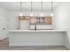 Basement wet bar with light wood cabinets and quartz countertop at 3826 N Elk St, Aurora, CO 80019