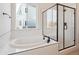Spa-like bathroom with soaking tub, walk-in shower, and large window at 3826 N Elk St, Aurora, CO 80019
