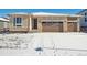 Ranch style home with two-car garage and snow-covered front yard at 3826 N Elk St, Aurora, CO 80019