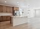 Modern kitchen with island, stainless steel appliances, and light wood cabinets at 3826 N Elk St, Aurora, CO 80019