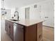 Modern kitchen island with quartz countertop and stainless steel dishwasher at 3826 N Elk St, Aurora, CO 80019