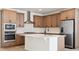 Modern kitchen with island, stainless steel appliances, and light wood cabinets at 3826 N Elk St, Aurora, CO 80019