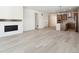 Spacious living room with hardwood floors, fireplace, and kitchen view at 3826 N Elk St, Aurora, CO 80019