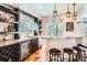 Stylish bar with a granite countertop, dark cabinets, wine storage, and modern pendant lighting at 4965 Huntwick Pl, Highlands Ranch, CO 80130
