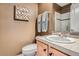 Cozy bathroom with tan walls, a sink, and a shower with a glass door at 4965 Huntwick Pl, Highlands Ranch, CO 80130