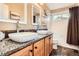 Modern bathroom showcasing double sinks with granite countertops and wood cabinets, alongside a shower and tub at 4965 Huntwick Pl, Highlands Ranch, CO 80130