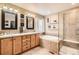 Bright bathroom features a double vanity, a bathtub, and a glass shower, providing a luxurious space at 4965 Huntwick Pl, Highlands Ranch, CO 80130