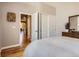 Bright bedroom with hardwood floors, and a closet with sliding doors, featuring a view into the hallway at 4965 Huntwick Pl, Highlands Ranch, CO 80130
