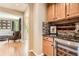 Butler pantry featuring upper and lower wood cabinets, wine storage and cooler at 4965 Huntwick Pl, Highlands Ranch, CO 80130