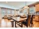 Open-concept dining room with hardwood floors, pendant lighting, and connected living room at 4965 Huntwick Pl, Highlands Ranch, CO 80130