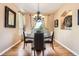 Dining room featuring hardwood floors, four chairs, and a modern chandelier at 4965 Huntwick Pl, Highlands Ranch, CO 80130