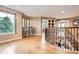 Bright foyer features hardwood floors, curved staircase, and large windows overlooking a green landscape at 4965 Huntwick Pl, Highlands Ranch, CO 80130
