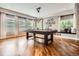 Well-lit game room showcasing a pool table, hardwood floors, large windows, and comfortable seating at 4965 Huntwick Pl, Highlands Ranch, CO 80130