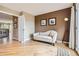 Comfortable seating area off the hallway, featuring wood floors, and view into the next room at 4965 Huntwick Pl, Highlands Ranch, CO 80130