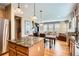 Open floor plan shows kitchen island, dining table and living room with lots of natural light at 4965 Huntwick Pl, Highlands Ranch, CO 80130